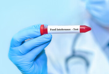 Doctor holding a test blood sample tube with food intolerance test.