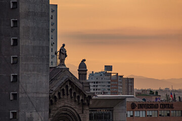 Fototapeta premium Bright sunset in Santiago Chile. Cityscape with sunset sky. Central University in Santiago