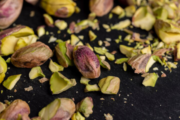 Scattered pistachios of green color with salty taste