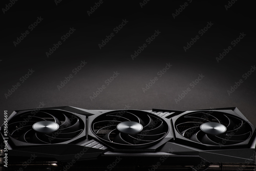 Aufkleber video card with three coolers from the computer on a dark background.concept computer harware.