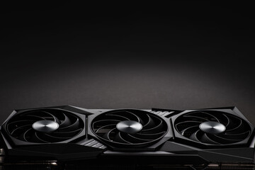 video card with three coolers from the computer on a dark background.concept computer harware.