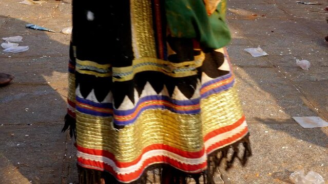 Closeup of man's legs wearing anklets or jingles and dancing at the temple