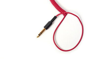 Red cord with a jack for connecting various gadgets, shot on a white background.