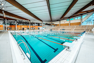 Swimming-Pool with equipment and large windows with a view outside