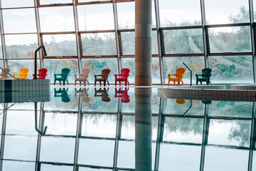 Swimming-Pool with equipment and large windows with a view outside