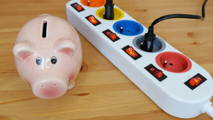 Energy saving concept. Saving money into piggy bank