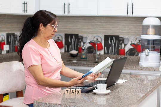 Woman with a surprised expression reviews the tax financial information from the comfort of her home
