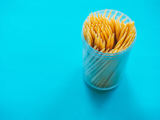 Wooden toothpicks on a blue background.