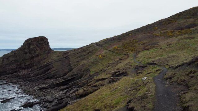Rugged Coast Path with Rickets Head and Crashing Waves with Dramatic Coastal Cliffs in Pembrokeshire UK 4K