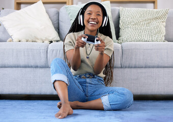 Black woman, gaming and smile with controller by living room sofa for fun match or online game at...
