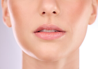 Obraz premium Woman, skincare or mouth in zoom of face for cosmetics, beauty and healthy glow on studio background. Girl model, lips and dermatology portrait of wellness, facial treatment in isolated closeup