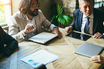 Multiracial business people working inside bank office - Focus on right senior face
