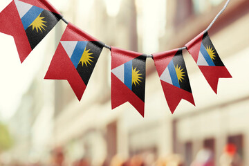 A garland of Antigua and Barbuda national flags on an abstract blurred background