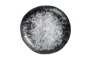 Menthol Crystals in a steel small plate. Isolated, transparent background