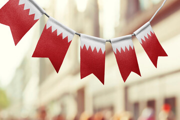 A garland of Bahrain national flags on an abstract blurred background