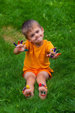 a smile painted with paints on the child's arms and legs.