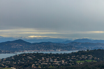 Winter on the Côte d'Azur - view over Golf of St. Tropez and St. Maxime with snow covered mountains, Provence, France