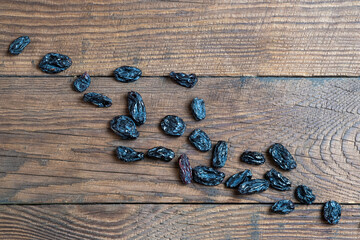 dry grapes on a wooden table. Background with raisins. Raisins on a wooden background