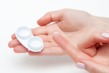 Contact Eye Lenses. Woman Hands Holding Contact Eye Lens. Woman Hands Holding White Eye lens Container. Beautiful Woman Fingers Holding Eye Lens Box. Health And Eyes Care Concept. High Resolution