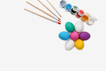 Colourful symbolic easter eggs and paintbrush with white background with copy space for text. Greeting card. Creative handmade diy craft bright idea. Preparation for holiday concept