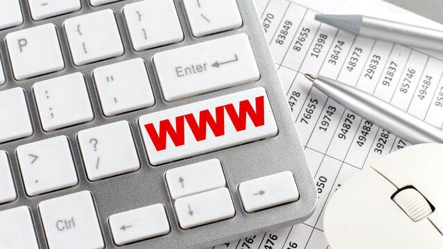 WWW text on a keyboard wirh chart and pencil