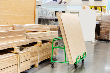 Sheets of plywood on a transport trolley. Trade in building materials from wood wholesale and retail. selective focus