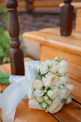 a beautiful bouquet of roses for the bride lies on the steps