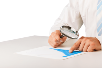 Reviewing results. Business with Magnifying Glass; and chart