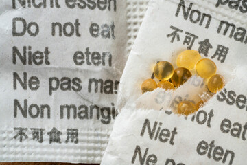 closeup of silica gel packages with cautions