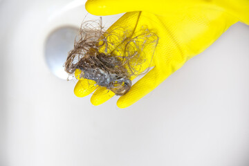 Shower drain is clogged with hair, Hair pile loss in a bathroom after wash hair in shower, cleaning...