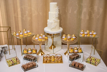 Candy bar with desserts for celebrating birthday, baptism, wedding. Table with cake, sweets, candies, dessert.