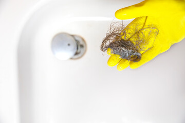 Shower drain is clogged with hair, Hair pile loss in a bathroom after wash hair in shower, cleaning...