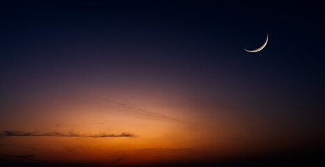 Crescent moon on dusk sky twilight after sundown, well free space for text Arabic religious of Islamic Ramadan Kareem, Eid al Fitr, Eid al Adha, Eid Mubarak  - obrazy, fototapety, plakaty
