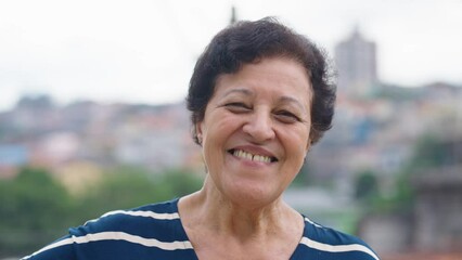 Closeup smiling senior woman posing at camera outdoor. Senior lady. 