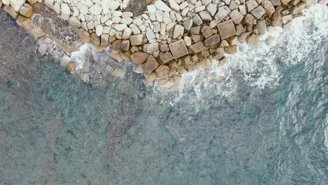 Aerial view of a breakwater along the coast in Acciaroli, Salerno, Campania, Italy.