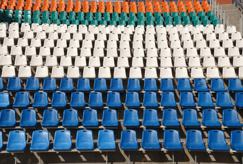 A grandstand with plastic seats in a small stadium