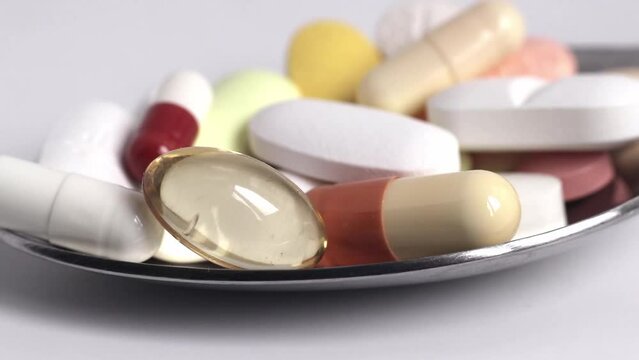Macro video of Medicinal Medicines piled in a metal spoon. Stock video.