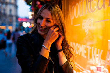 Woman wearing casual clothes walking in warm autumn evening city