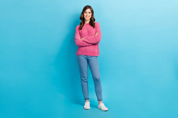 Full body photo of young positive attractive model woman wear stylish outfit pink jumper denim jeans folded hands isolated on blue color background