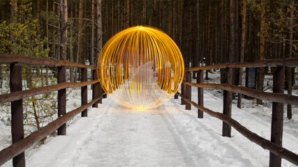 Yellow light orb in winter forrest