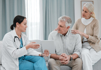 Nurse with tablet results consulting old couple in hospital after surgery or medical test report...