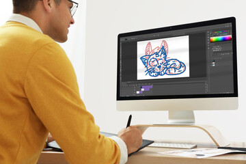 Animator working with graphic tablet and computer. Illustration on screen