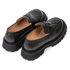 New women's black leather shoes with thick soles without heels on a white background with shadow