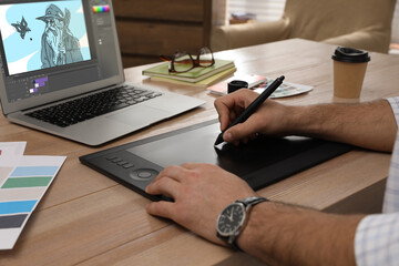 Animator working with graphic tablet and laptop, closeup. Illustration on screen