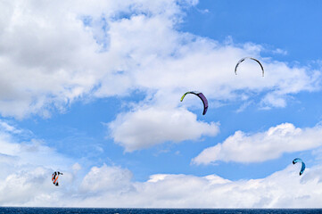 People practicing kitesurfing on the beach of Los Caños de Meca, next to the Trafalgar Lighthouse,...
