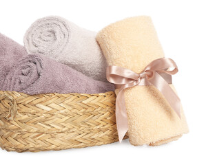 Fototapeta na wymiar Wicker basket and rolled bath towels on white background