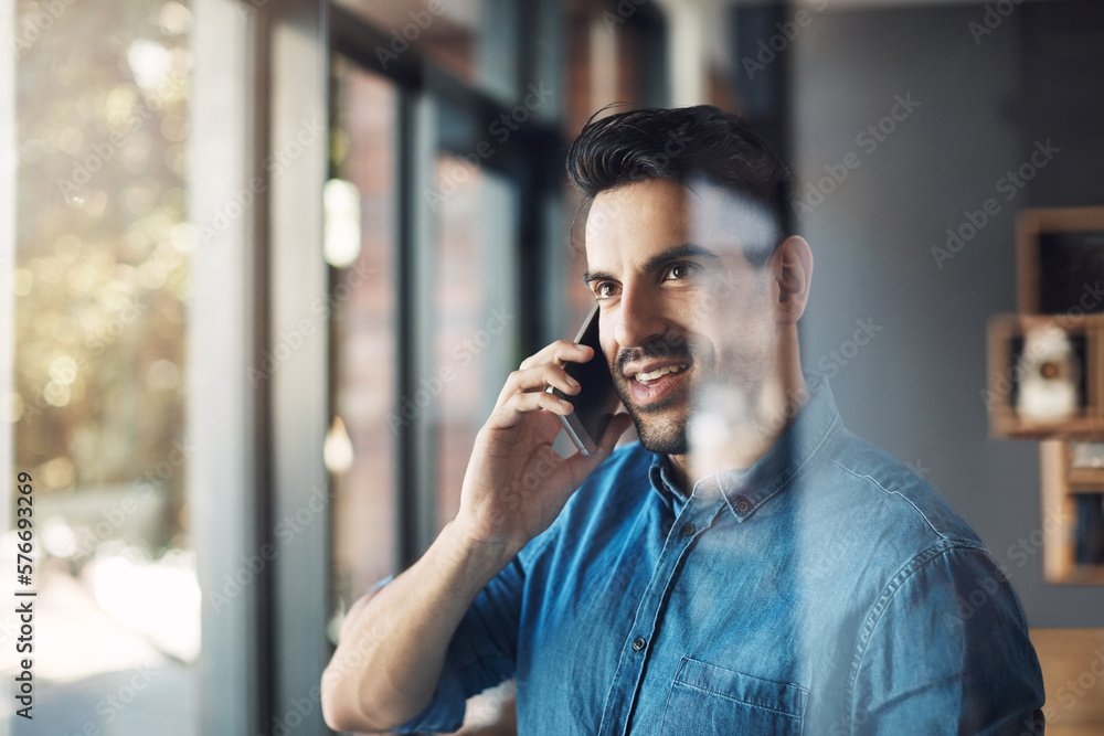 Leinwandbilder always connected, always in the know. shot of a young man using a mobile phone to make a call in a m