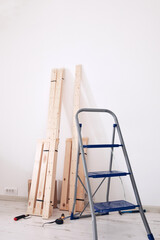 Rustic wooden material for new shelves in a modern apartment.