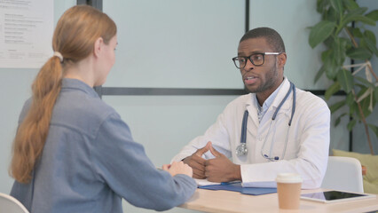 African Doctor Talking with Female Patient