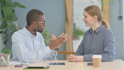 Young African Businessman Discussing Work with Partner